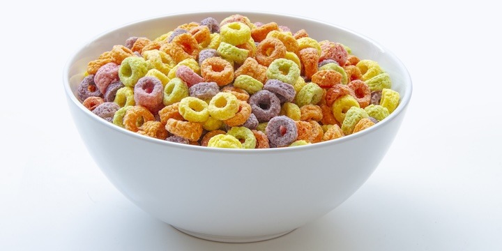 Sweetened Cereal fruit-flavored ring-shaped on a variety of bright colors and a blend of fruit flavors. Red, orange, yellow, green, blue and purple ring-shaped